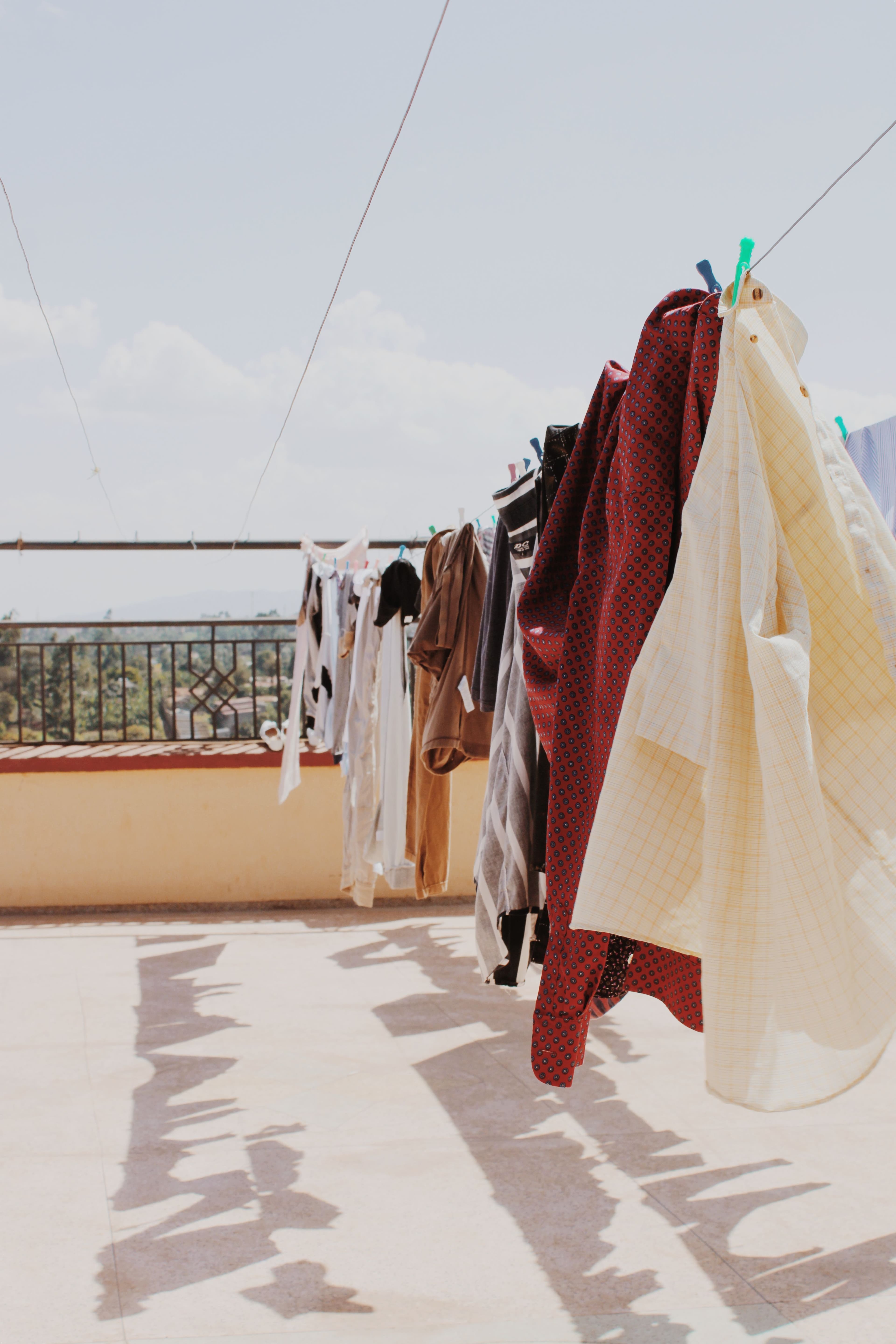Fresh, colorful laundry hanging on a clothesline on a sunlit balcony.